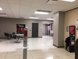 The interior of Wells Library, just past the doors from the patio entrance. The Bookmarket Eatery is ahead and to the right, and there is a hallway to the left of the Eatery.