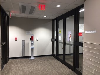 Two sets of double doors at the end of the hallway outside of the Bookmarket Eatery. The doors to the right lead to CESE office.