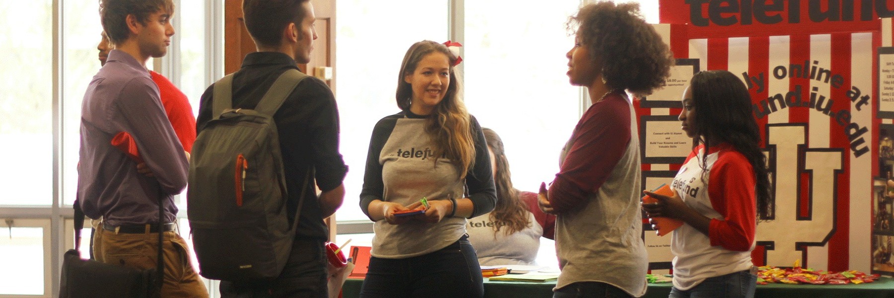 Five students having a discussion at a Telefund event